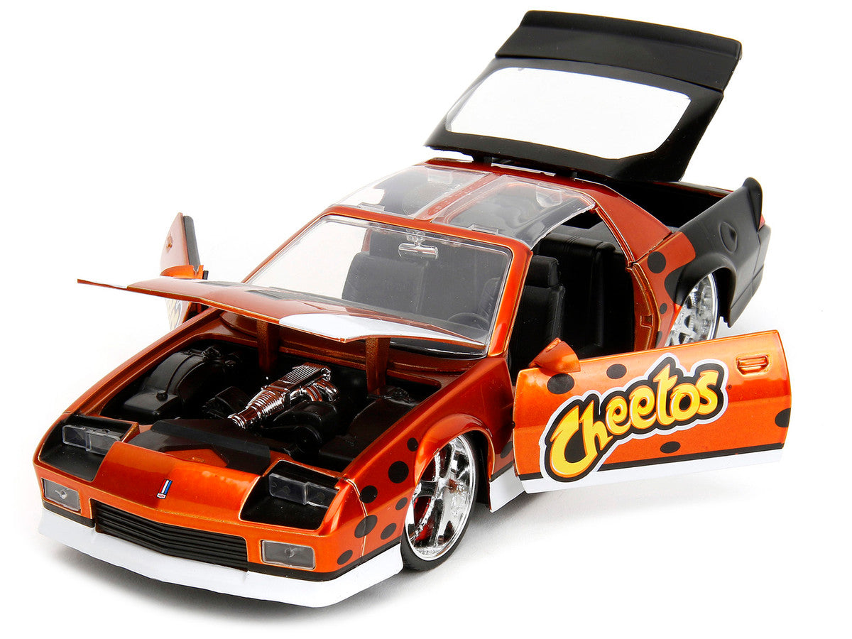 1985 Chevrolet Camaro Z/28 Orange Metallic with Graphics and Chester Cheetah Diecast Figure "Cheetos" "Hollywood Rides" Series 1/24 Diecast Model Car by Jada Jada