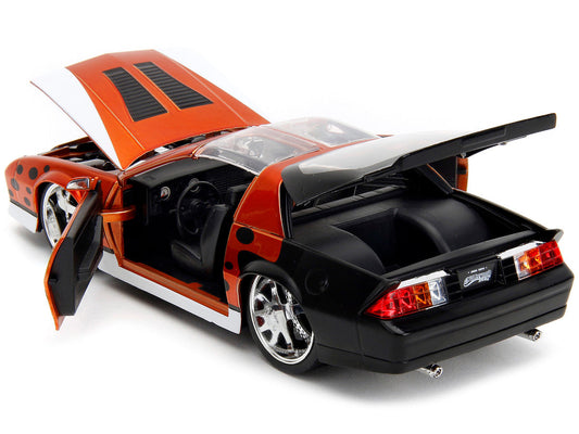 1985 Chevrolet Camaro Z/28 Orange Metallic with Graphics and Chester Cheetah Diecast Figure "Cheetos" "Hollywood Rides" Series 1/24 Diecast Model Car by Jada Jada