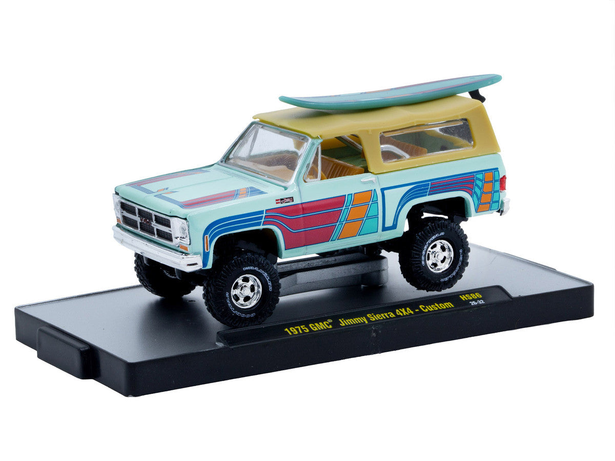 1975 GMC Jimmy Sierra 4x4 Light Blue with Graphics and Tan Top with Surfboard Limited Edition to 10560 pieces Worldwide 1/64 Diecast Model Car by M2 Machines M2