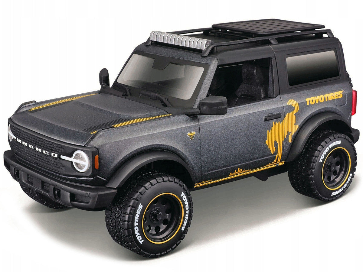 2021 Ford Bronco Badlands Dark Gray Metallic with Gold Graphics and Roof Rack "Off-Road" "Maisto Design" Series 1/24 Diecast Model Car by Maisto Maisto