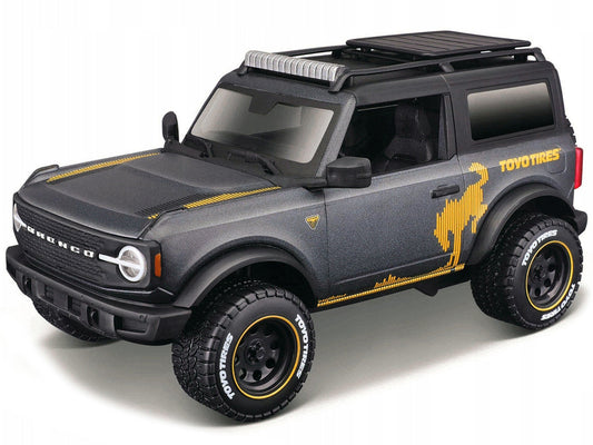2021 Ford Bronco Badlands Dark Gray Metallic with Gold Graphics and Roof Rack "Off-Road" "Maisto Design" Series 1/24 Diecast Model Car by Maisto Maisto