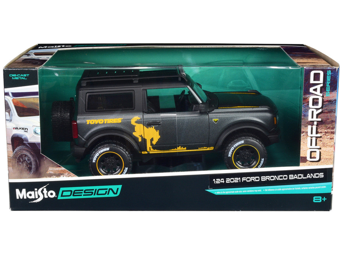 2021 Ford Bronco Badlands Dark Gray Metallic with Gold Graphics and Roof Rack "Off-Road" "Maisto Design" Series 1/24 Diecast Model Car by Maisto Maisto