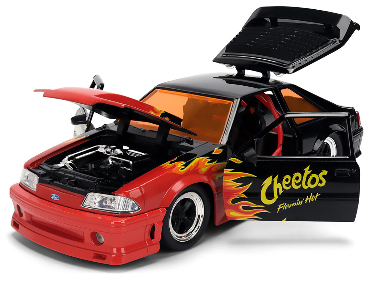 1989 Ford Mustang GT Black with Red Flame Graphics and Chester Cheetah Diecast Figure "Cheetos Flamin' Hot" "Hollywood Rides" Series 1/24 Diecast Model Car by Jada Jada