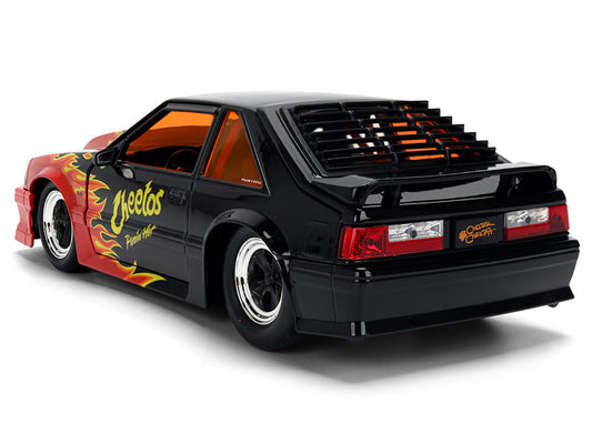 1989 Ford Mustang GT Black with Red Flame Graphics and Chester Cheetah Diecast Figure "Cheetos Flamin' Hot" "Hollywood Rides" Series 1/24 Diecast Model Car by Jada Jada