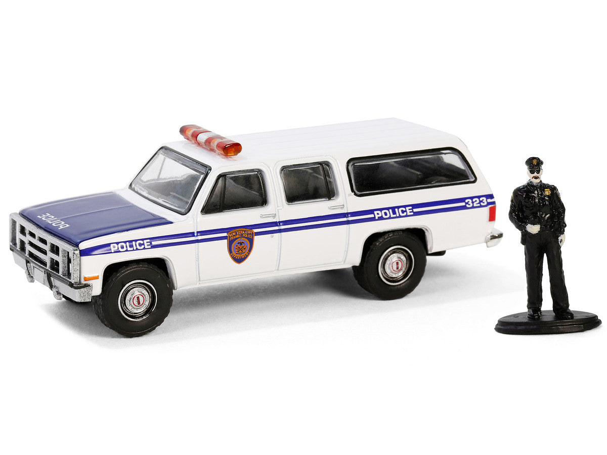 1985 GMC Suburban 2500 "New York City Transit Police Department" White with Blue Stripes and Police Officer Figure "The Hobby Shop" Series 16 1/64 Diecast Model Car by Greenlight Greenlight