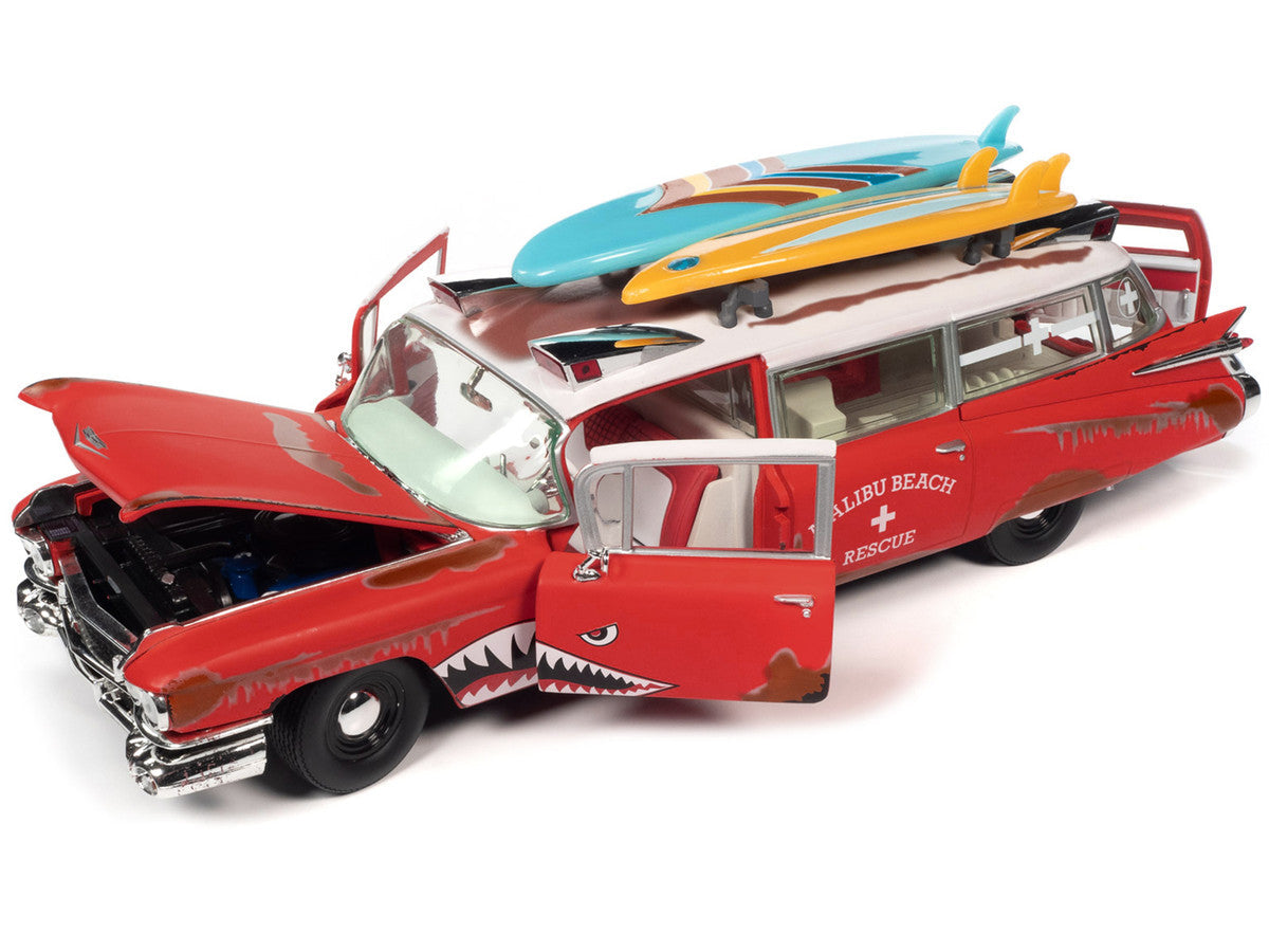 1959 Cadillac Eldorado Ambulance Red with White Top "Malibu Beach Rescue" (Weathered) with Surfboards on Roof "Surf Shark" 1/18 Diecast Model Car by Auto World Autoworld