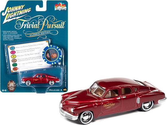 1948 Tucker Torpedo Red Maroon Metallic "Tucker: The Man and His Dream" (1988) Movie with Poker Chip (Collector Token) and Game Card "Trivial Pursuit" "Pop Culture" Series 3 1/64 Diecast Model Car by Johnny Lightning Johnny Lightning