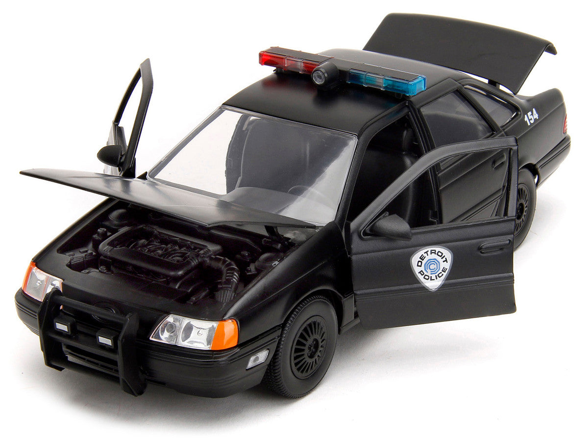 Ford Taurus OCP Matt Black "Detroit Police" and Robocop Diecast Figure 35th Anniversary "Robocop" (1987) Movie "Hollywood Rides" Series 1/24 Diecast Model Car by Jada Jada