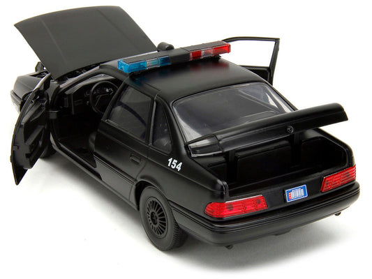 Ford Taurus OCP Matt Black "Detroit Police" and Robocop Diecast Figure 35th Anniversary "Robocop" (1987) Movie "Hollywood Rides" Series 1/24 Diecast Model Car by Jada Jada