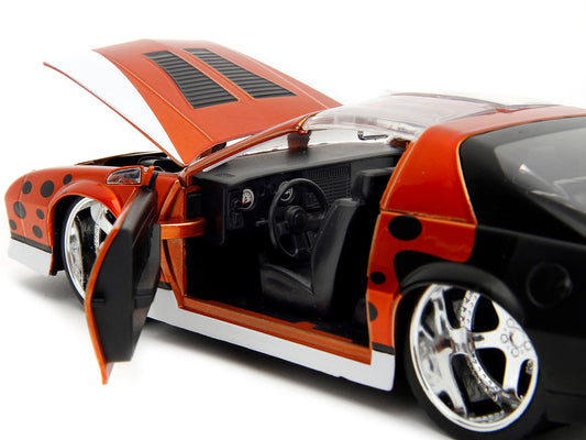 1985 Chevrolet Camaro Z/28 Orange Metallic with Graphics and Chester Cheetah Diecast Figure "Cheetos" "Hollywood Rides" Series 1/24 Diecast Model Car by Jada Jada